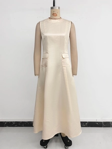 Detail of elegant beige sleeveless satin maxi dress with round neck and side flap pockets