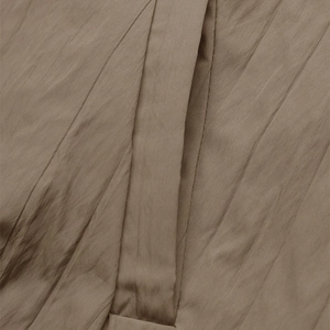 Detailed close-up of textured fabric showing fine vertical stripes and stitching of cardigan