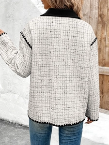 Rear view of a tweed cropped jacket with black wavy trim and lapel collar details