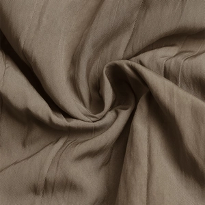 Macro detail of brown textured fabric with fine grid pattern and soft pleated texture