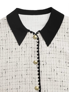 Detail of tweed jacket featuring black lapel, gold buttons and wavy trim texture