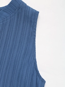 Detailed close-up of blue textured waffle knit fabric on a summer casual dress