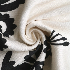 Macro shot of boho floral print fabric with geometric patterns on a creamy white base
