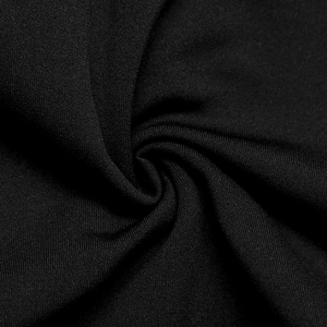 Close-up of black knitted fabric showing fine texture and soft elastic material detail