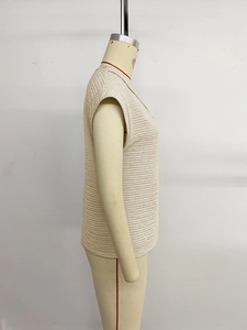 Detailed view of women's t-shirt showing textured horizontal ripple pattern on beige fabric