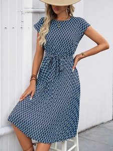 Detail view of navy blue dress with geometric patterns and adjustable waist drawstring