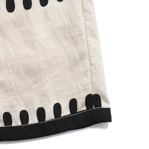 Detailed macro view of linen fabric texture with black print and hem stitching