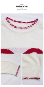 Detail of white knit sweater showing red blanket stitch hem and festive jacquard pattern