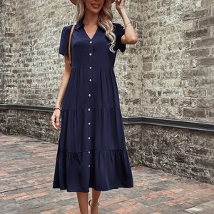 Short sleeve navy blue tiered midi shirt dress with gold buttons and a V-neck collar