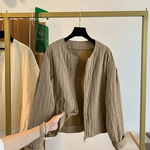 Women's minimalist khaki zip-up jacket with textured fabric and a sleek round neckline