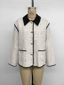 Detail of tweed jacket with four functional pockets and contrast black trim