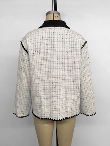 Rear view of a tweed jacket featuring black lapels and detailed wavy hemline accents