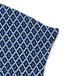 Detailed close-up showing blue geometric print and fine stitching on a summer dress sleeve
