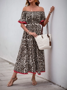 Outdoor street shot of leopard print off-shoulder maxi dress with red contrast piping detail