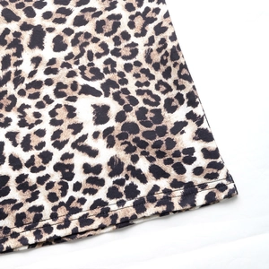 Close-up of leopard print fabric hem showing detailed double-needle flat stitching