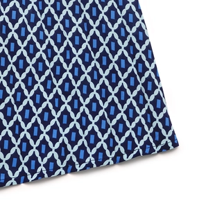 Detail of blue geometric diamond print fabric with clean flat-stitched hem on the dress
