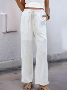 Detail showing the white linen high waist pants with drawstring and large side pockets