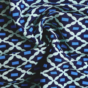 Detailed macro shot showing the soft texture and geometric plaid pattern of the printed fabric