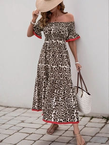 Detail of off-shoulder leopard print maxi dress with red trim and tiered hem