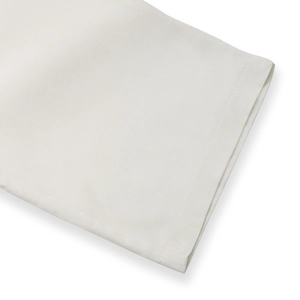 Detail view showing breathable white linen fabric texture and fine stitched hemline