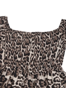 Close-up of leopard print dress featuring elastic smocking detail and a square neckline