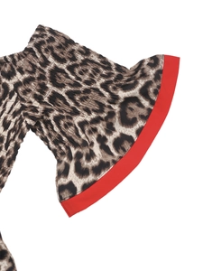 Detail of leopard print fabric with elastic smocking and contrast red hem trim