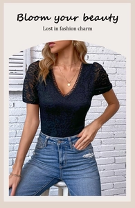 Close-up of elegant black lace bodysuit featuring delicate V-neck and floral embroidery