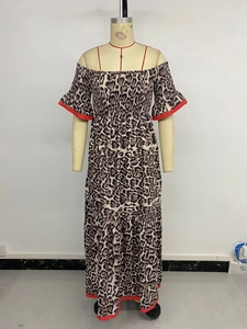 Close-up of leopard print maxi dress with elastic smocked chest and red contrast trim