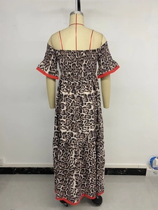 Detail of red hem borders and elastic smocked bodice on leopard print maxi dress