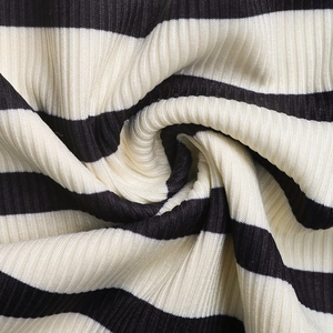 Macro shot of black and white striped ribbed knit fabric showing soft texture and weaving