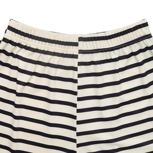 Detailed view of elastic waistband and ribbed texture on black and white striped shorts