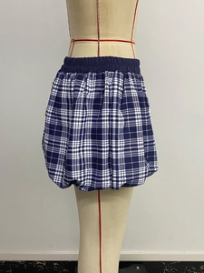 Detail of blue and white plaid bubble skirt featuring elastic waistband on a mannequin
