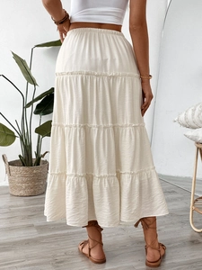 Back view of a creamy tiered maxi skirt with elastic waist and boho pleated layers