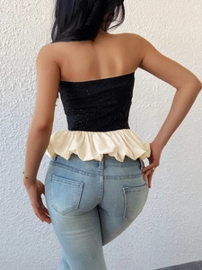Classic black and white peplum strapless top with glitter detailing and ruffled hem