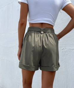 Detail view of olive green textured shorts with a back button and rolled hems