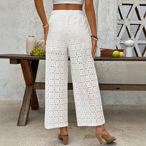 White lace crochet high waist wide leg pants for women in a Mediterranean outdoor setting