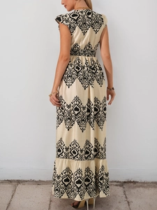 Detail view showing black floral print and elastic waist on back of bohemian maxi dress