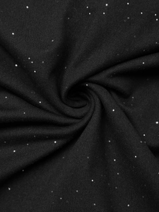 Detail shot of black knit fabric with silver sequins featuring starry night visual texture