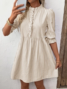 Detail of ruffled stand-up collar and vertical stripes on puff sleeve dress