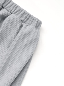 Detail of dark grey ribbed knit fabric and elastic waistband on a summer skirt