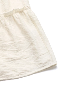 Detailed view of cream cotton-linen fabric with ruffle stitching and natural texture