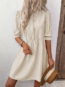 Close-up of vintage striped dress with ruffle collar and puff sleeves for summer wear