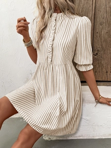 Detail of ruffled collar and button-down front on vertical striped shirt dress
