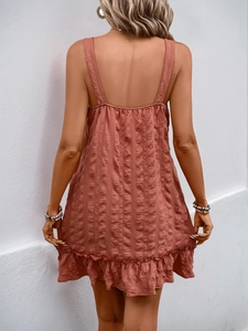 Detail of the textured fabric and backless design on a rose red summer cami dress