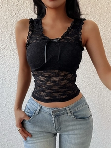 Detail of black lace camisole featuring floral patterns and a V-neck bow tie