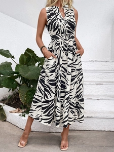 Detail of zebra print sleeveless V-neck dress with smocked waist and tiered skirt layers