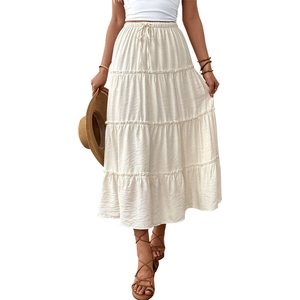 Elegant white tiered A-line maxi skirt with elastic waist and bohemian summer style