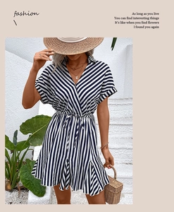 Detail of waist-tie design on a blue and white striped summer dress with ruffles