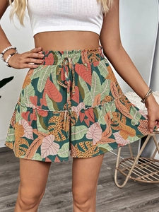 Detail of high waist tropical leaf print shorts with drawstring and ruffled hemline