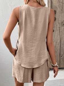 Rear view of beige sleeveless top and shorts set with side tie details and textured fabric